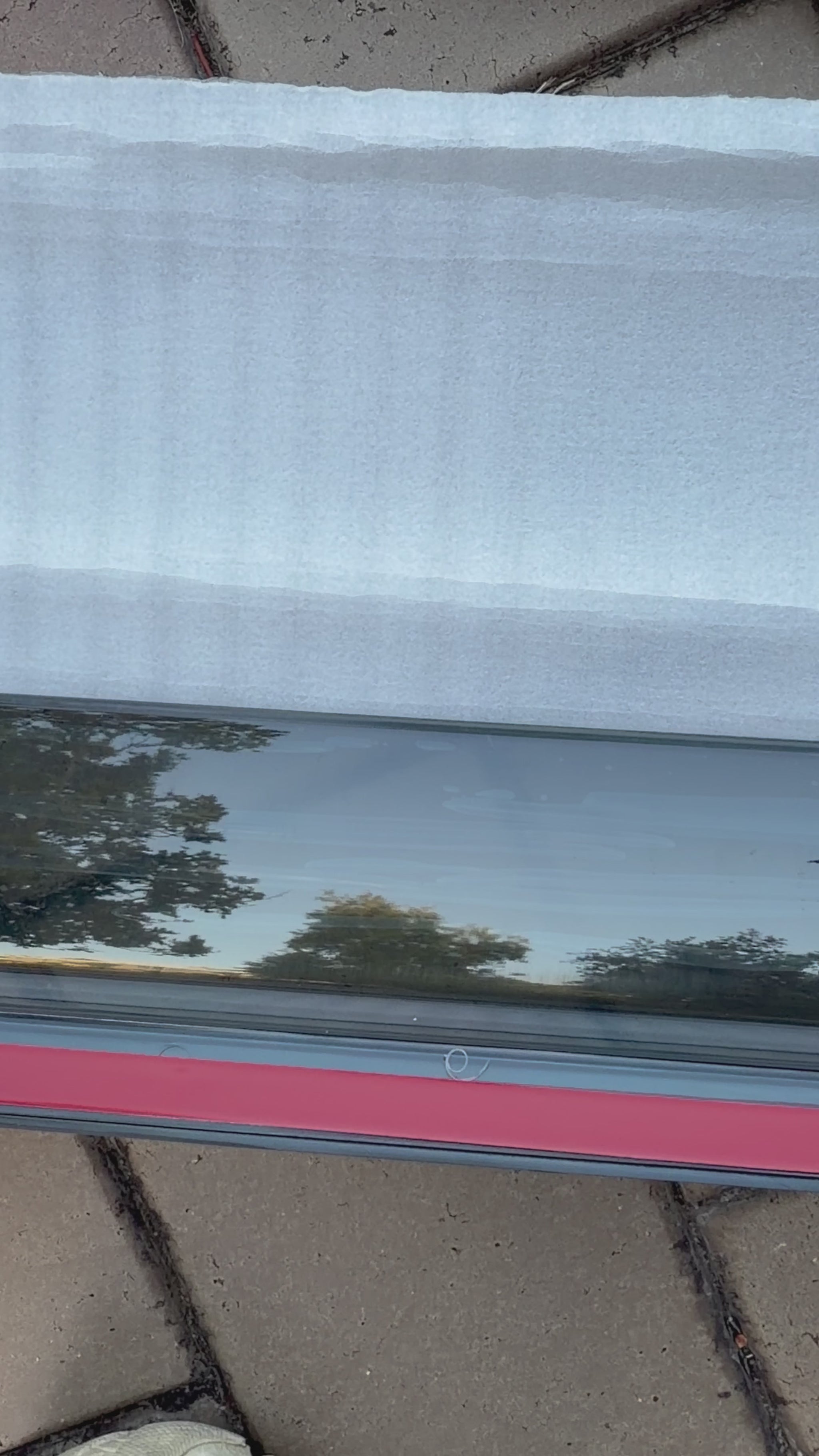 Close up of Iron Devil brand BYD Shark 6 window visor on tile